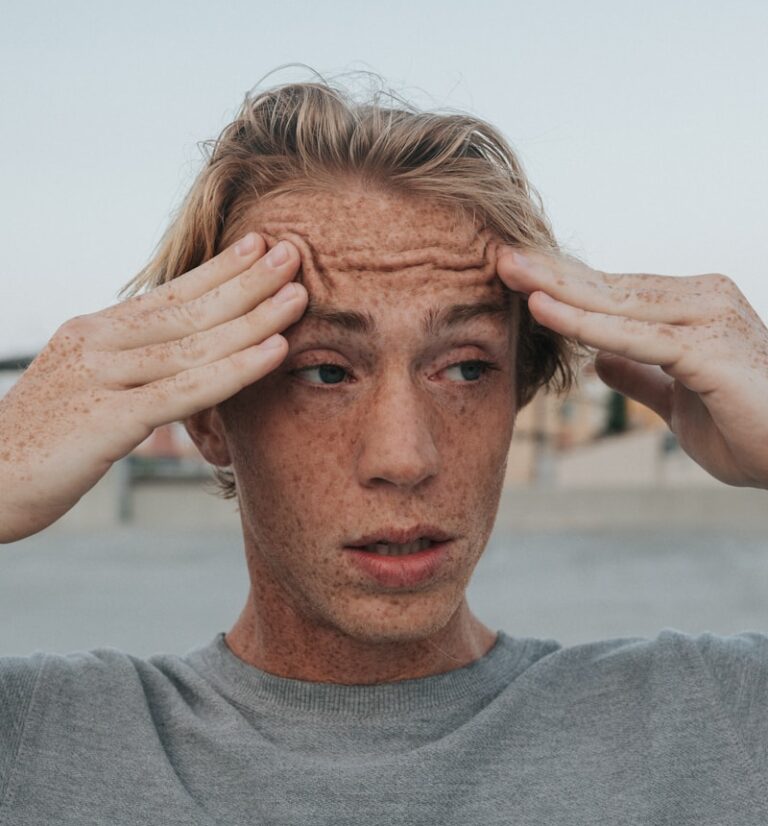 man in gray crew neck shirt with brown hair